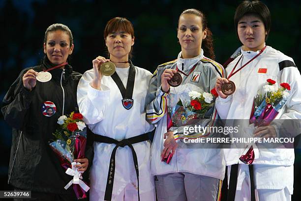 Gold medalist Korean Sin Kyung Hyeon displays his medal flanked by silver medalist Puerto Rico's Iniabelle Diaz and Belgium's Laurence Rase and...