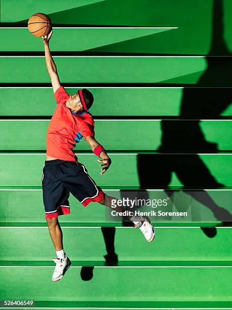 athlete performing in green sportsarena - basketball teen stock pictures, royalty-free photos & images