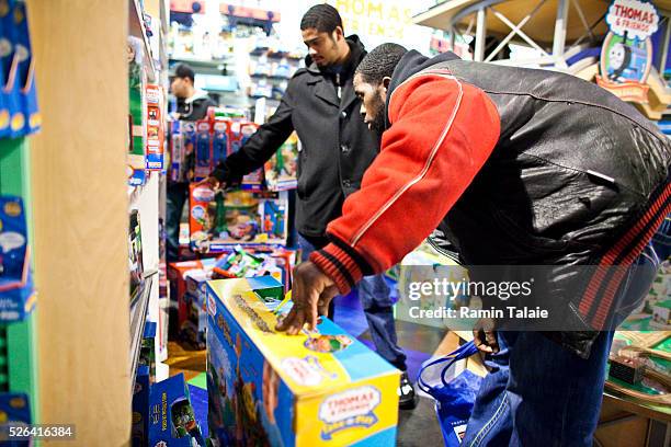 Shoppers make last minute Christmas purchases in Toys 'R' Us flagship store in Times Square in New York City, on Friday, December 23, 2011.