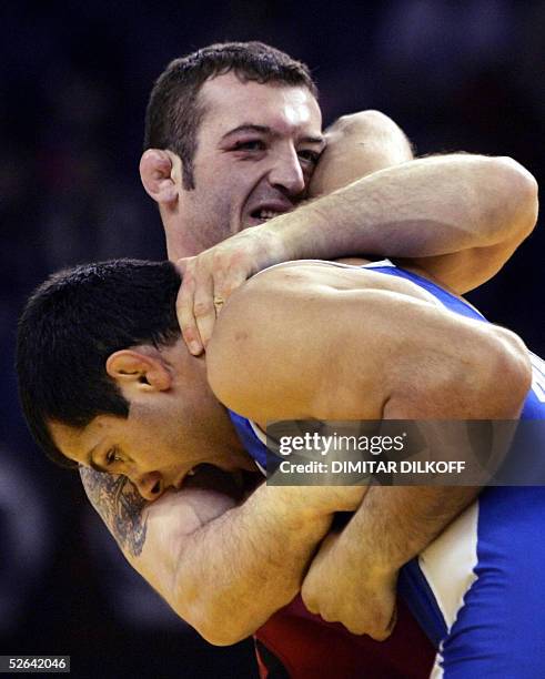 Velin Marinov of Bulgaria grapples Movses Karapetyan of Armenia during their Greco-Roman style, 74 kilo final match at the European Championship, in...