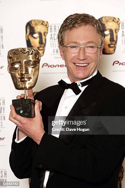 Comedian Paul O'Grady poses in the awards room with the Features Award for Ramsay's Kitchen Nightmares at the Pioneer British Academy Television...