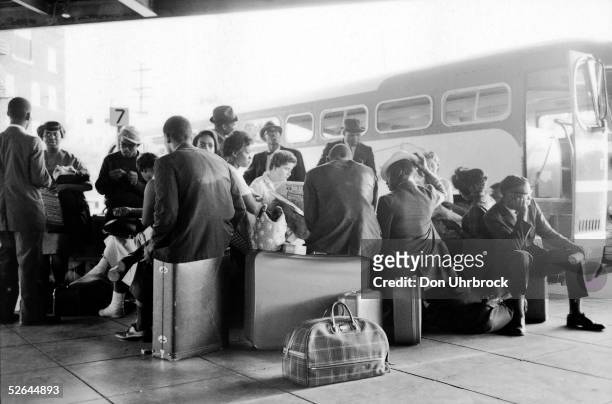 Freedom Riders sit on their luggage at a bus station, Birmingham, Alabama, May 1961. As part of a protest against the racial segregation of...