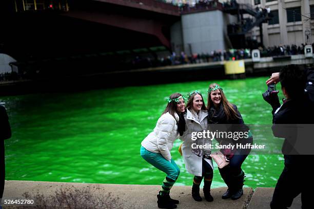 People enjoy the Chicago River, which was dyed Green during a St Patricks Day paraden in Chicago, IL on Saturday, March 16, 2013. There was Green...