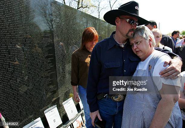 Ken Costner hugs Kay Lawrence from Indianapolis, Indiana as they pay tribute to her husband James Richard Lawrence who served in the military during...