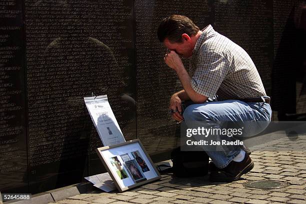 Patrick Duff from Laguna Niguel, California grieves next to a memorial they built for his brother Michael James Duff who served in the military...