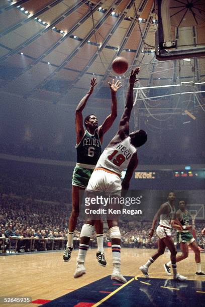 Bill Russell of the Boston Celtics shoots over Willis Reed of the New York Knicks circa 1965 at Madison Square Garden in New York, New York. NOTE TO...