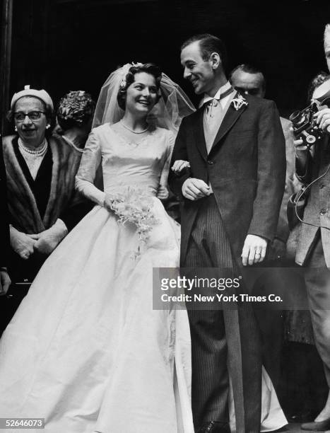 American figure skaters Carol Heiss and Hayes Alan Jenkins pose for photographers just after their marriage, New York, New York, April 30, 1960.