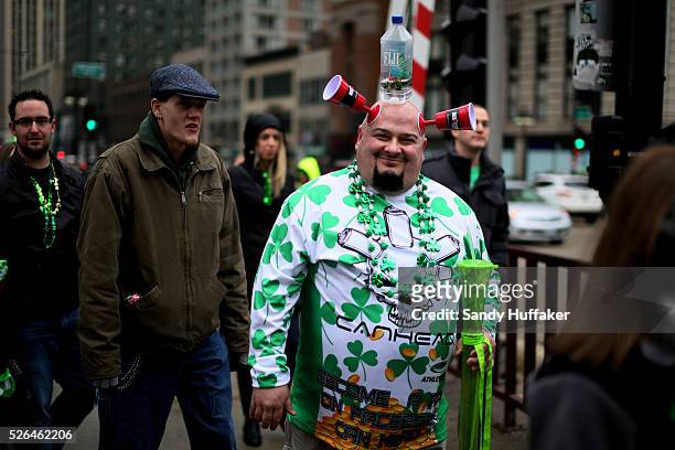 People watch the festivities, some dressed in Irish themed costumes, during a St Patricks Day paraden in Chicago, IL on Saturday, March 16, 2013....