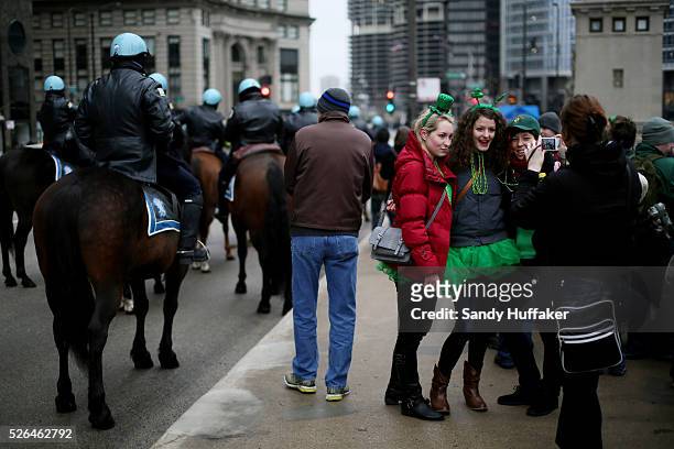 People watch the festivities, dressed in Irish themed costumes, during a St Patricks Day paraden in Chicago, IL on Saturday, March 16, 2013. There...