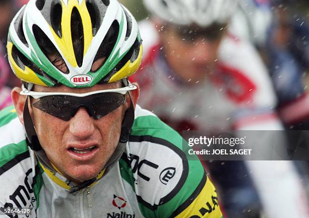 File photo taken 11 July 2004 shows US Tyler Hamilton riding under the rain during the eighth stage of the 91st Tour de France cycling race between...