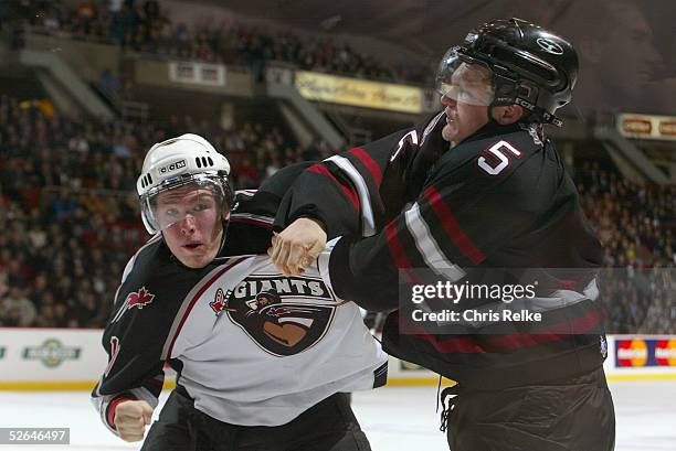 Watt of the Red Deer Rebels fights with Pierre-Paul Lamoureux of the Vancouver Giants at Pacific Coliseum on February 16, 2005 in Vancouver, British...