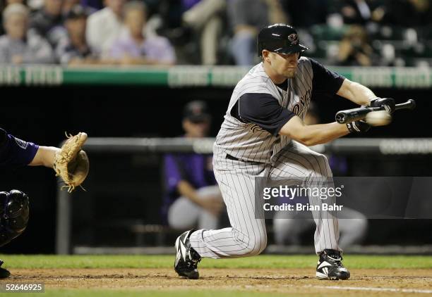 Pitcher Brandon Webb of the Arizona Diamondbacks lays down a bunt to advance the runner against catcher J.D. Closser of the Colorado Rockies in the...