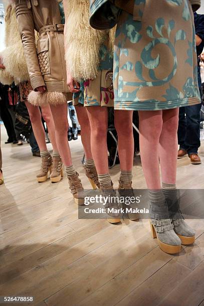 Models wait backstage before the Matthew Williamson autumn 2011 collection at Phillips de Pury Gallery in London on 20 February 2011.