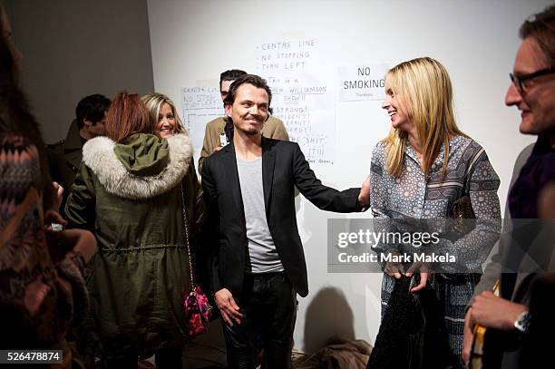 Designer Matthew Williamson is congratulated after unveiling his autumn 2011 collection at Phillips de Pury Gallery in London on 20 February 2011.