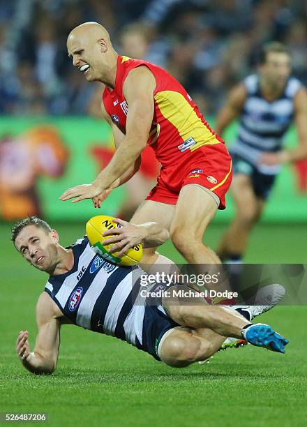 Gary Ablett of the Suns tackles Joel Selwood of the Cats during the round six AFL match between the Geelong Cats and the Gold Coast Suns at Simonds...