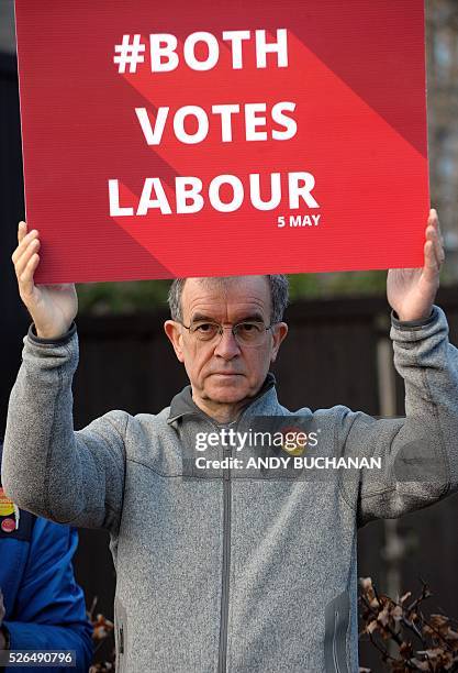 Scottish Labour suppporter holds a banner as leader Kezia Dugdale unveils a new election campaign poster on Leith Walk in Edinburgh on April 30,...