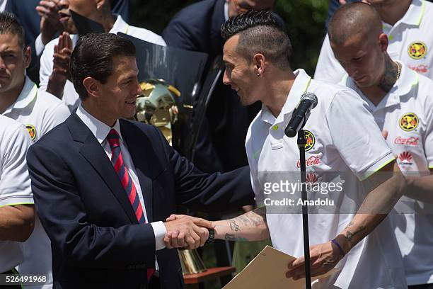 President of Mexico, Enrique Pena Nieto and Club America 's captain, Rubens Sambueza are seen during a visit of Club America to the Los Pinos...