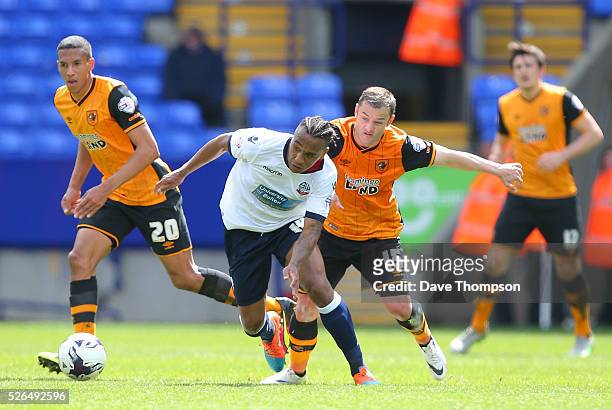 Neil Danns of Bolton Wanderers controls the ball under pressure of Shaun Maloney of Hull City during the Sky Bet Championship match between Bolton...