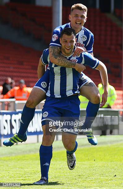 Yanic Wildschut of Wigan Athletic celebrates with team mate Max Power as he scores their third goal during the Sky Bet League One match between...