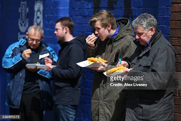 Fans have meals outside the stadium prior to the Barclays Premier League match between Everton and A.F.C. Bournemouth at Goodison Park on April 30,...