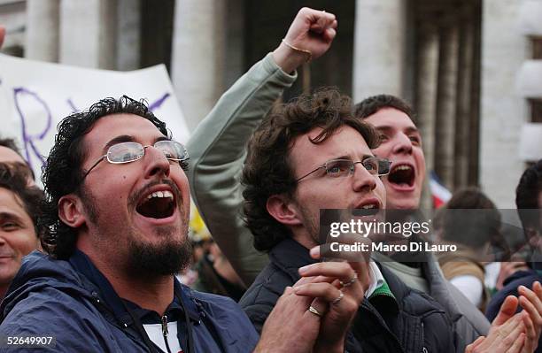 The crowd reacts as white smoke rises from the Sistine Chapel, signaling a new pope has been elected, during the second day of the conclave April 19,...