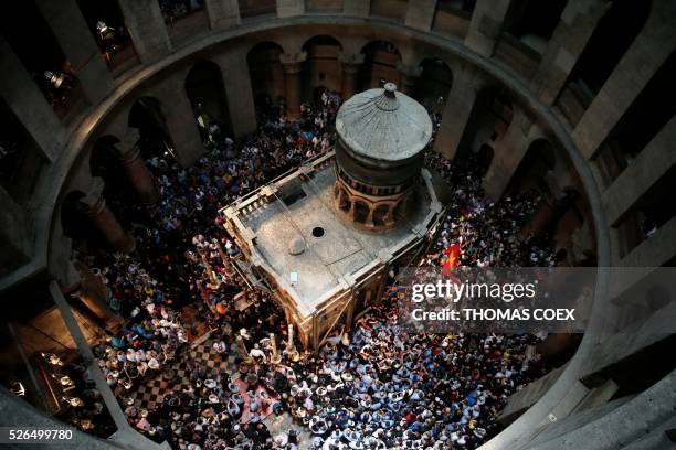 Christian Orthodox worshippers dance and pray around the Tomb of Jesus as thousands gather in the Church of the Holy Sepulchre in Jerusalem's Old...