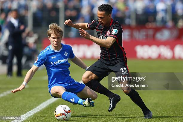 Aenis Ben-Hatira of Frankfurt is challenged by Florian Jungwirth of Darmstadt during the Bundesliga match between SV Darmstadt 98 and Eintracht...