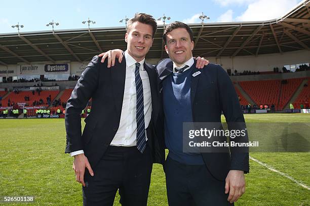 Wigan Athletic chairman David Sharpe and manager Gary Caldwell celebrate promotion to the Championship after the Sky Bet League One match between...