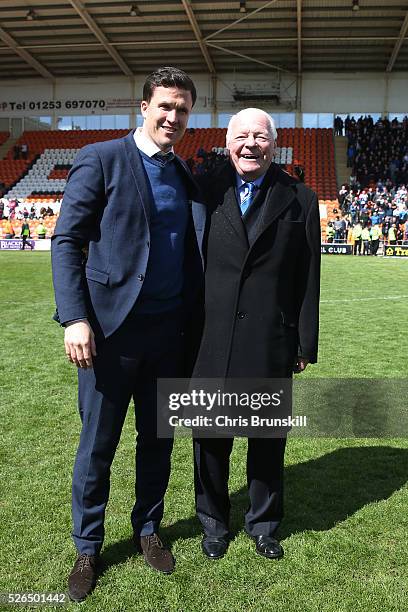 Wigan Athletic manager Gary Caldwell and owner Dave Whelan celebrate promotion to the Championship after the Sky Bet League One match between...