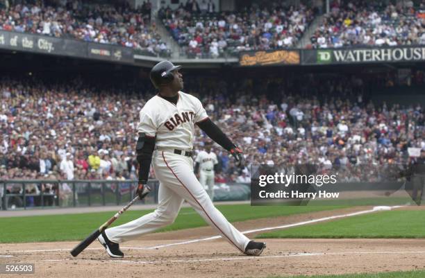 Barry Bonds of the San Francisco Giants watches his 73rd home run hit against the Los Angeles Dodgers during the first inning at Pacific Bell Park in...