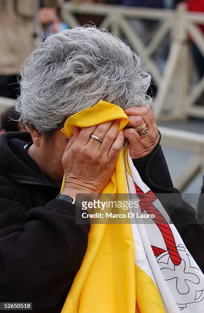 The a woman cries as German Cardinal Joseph Ratzinger speaks after appearing on the balcony of St.Peter's Cathedral as Pope Benedict XVI at the end...