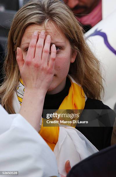 Woman crosses herself as German Cardinal Joseph Ratzinger speaks after appearing on the balcony of St.Peter's Cathedral as Pope Benedict XVI at the...