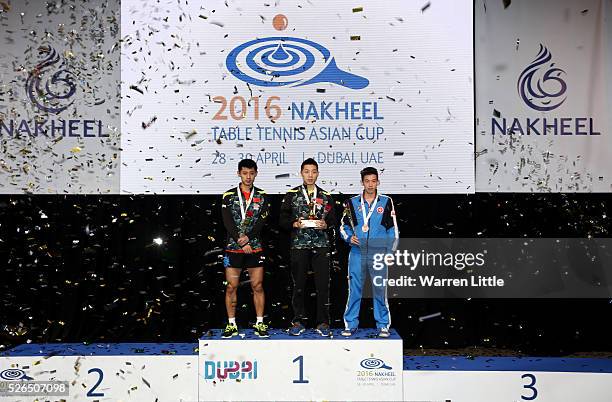 Zhang Jike of China, Xu Xin of China and Wong Chun Ting of Hong Kong pose on the podium after the Men's singles final of the Nakheel Table Tennis...