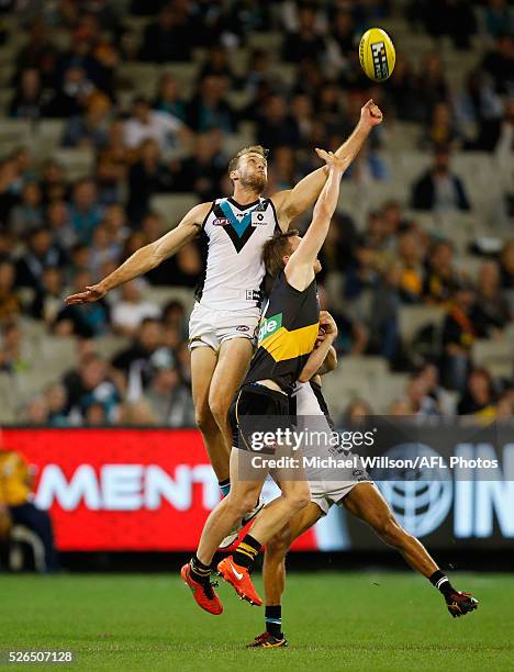 Jack Hombsch of the Power and Jack Riewoldt of the Tigers compete for the ball during the 2016 AFL Round 06 match between the Richmond Tigers and...