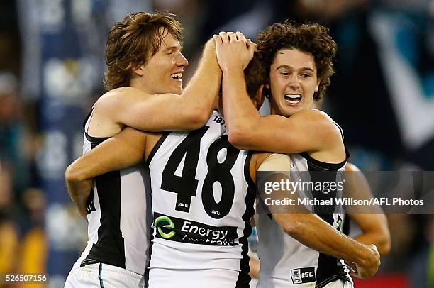 Jared Polec, Nathan Krakouer and Darcy Byrne-Jones of the Power celebrate during the 2016 AFL Round 06 match between the Richmond Tigers and Port...