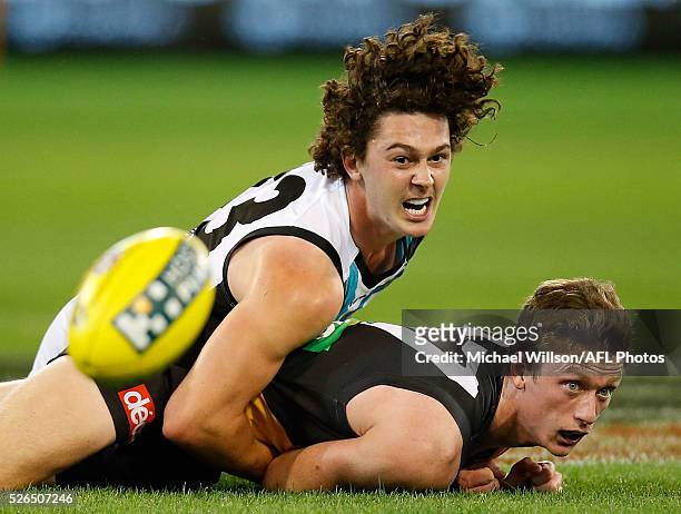 Darcy Byrne-Jones of the Power and Connor Menadue of the Tigers compete for the ball during the 2016 AFL Round 06 match between the Richmond Tigers...
