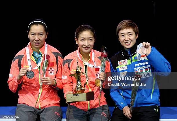 Li Xiaoxia of China, Liu Shiwen and Feng Tianwei of Singapore pose on the podium after the Women's singles final of the Nakheel Table Tennis Asian...