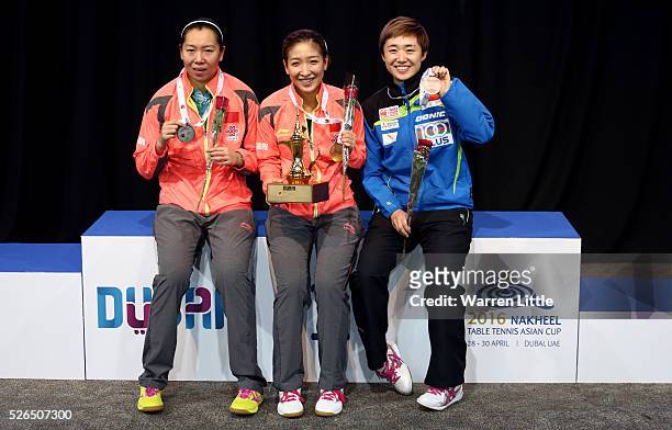 Li Xiaoxia of China, Liu Shiwen and Feng Tianwei of Singapore pose on the podium after the Women's singles final of the Nakheel Table Tennis Asian...