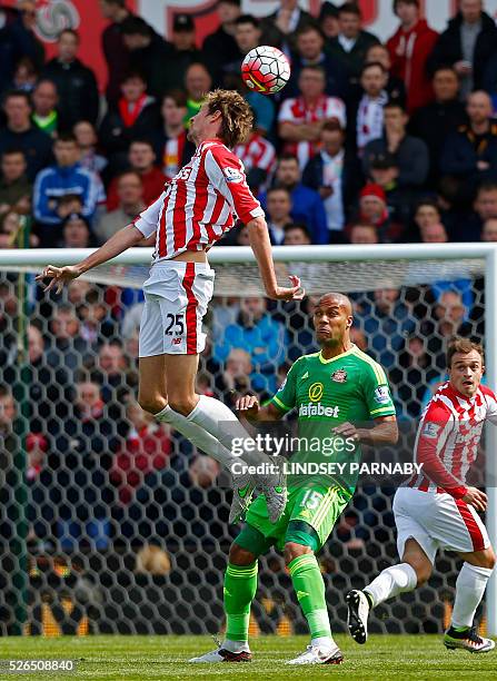 Stoke City's English striker Peter Crouch beats Sunderland's French defender Younes Kaboul to the ball during the English Premier League football...