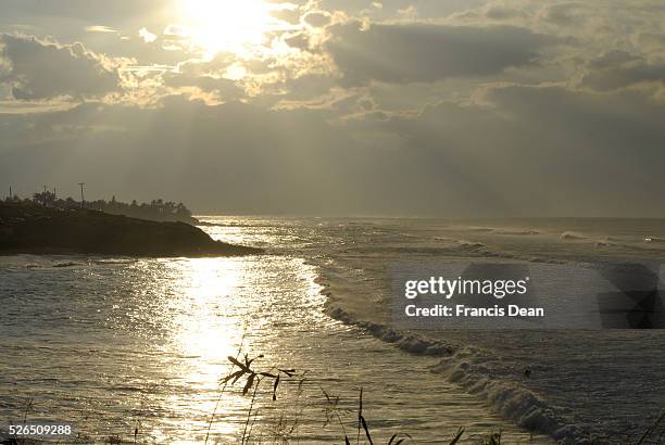 Maui .Hawaii islands ,USA _Female tourists watching sunset high tides and fursboarding at Maui coast on 23 January 2015 Photo by Francis Joseph...