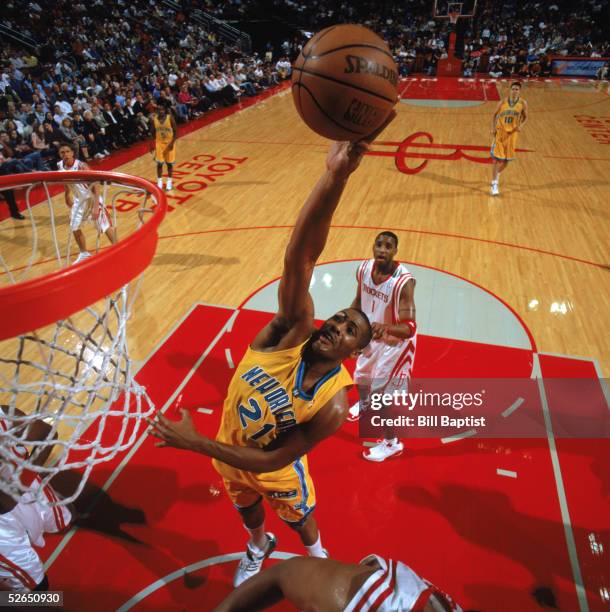 Jamaal Magloire of the New Orleans Hornets goes up for a shot during a game against the Houston Rockets at Toyota Center on April 1, 2005 in Houston,...