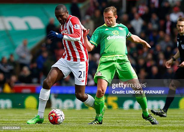 Sunderland's captain English midfielder Lee Cattermole challenges Stoke City's Congolese Gianelli Imbula during the English Premier League football...