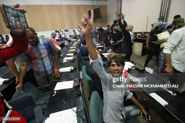 Iraqi protesters shout slogans as they sit inside the parliament after breaking into Baghdad's heavily fortified "Green Zone" on April 30, 2016....