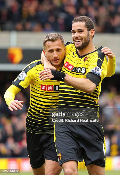 Almen Abdi of Watford celebrates scoring his team's first goal with his team mate Mario Suarez during the Barclays Premier League match between...