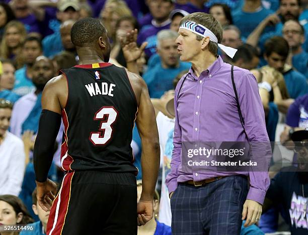 Dwyane Wade of the Miami Heat reacts after making a shot late in the fourth quarter against the Charlotte Hornets during game six of the Eastern...