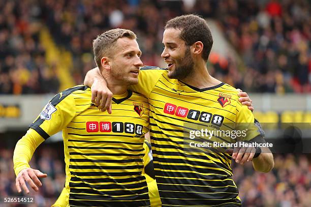 Almen Abdi of Watford celebrates scoring his team's first goal with his team mate Mario Suarez during the Barclays Premier League match between...