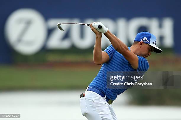 Rickie Fowler hits his second shot on the 18th hole during the continuaiton of the second round of the Zurich Classic of New Orleans at TPC Louisiana...