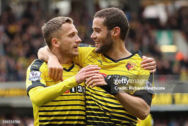 Almen Abdi of Watford celebrates scoring his team's first goal with his team mate Mario Suarez during the Barclays Premier League match between...