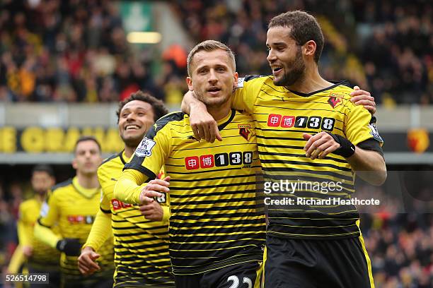 Almen Abdi of Watford celebrates scoring his team's first goal with his team mate Mario Suarez during the Barclays Premier League match between...