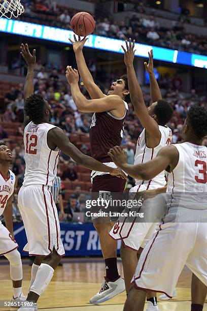 Tyler Davis of the Texas A&M Aggies puts up a shot against Khadeem Lattin of the Oklahoma Sooners during the West Regional Semifinal of the 2016 NCAA...